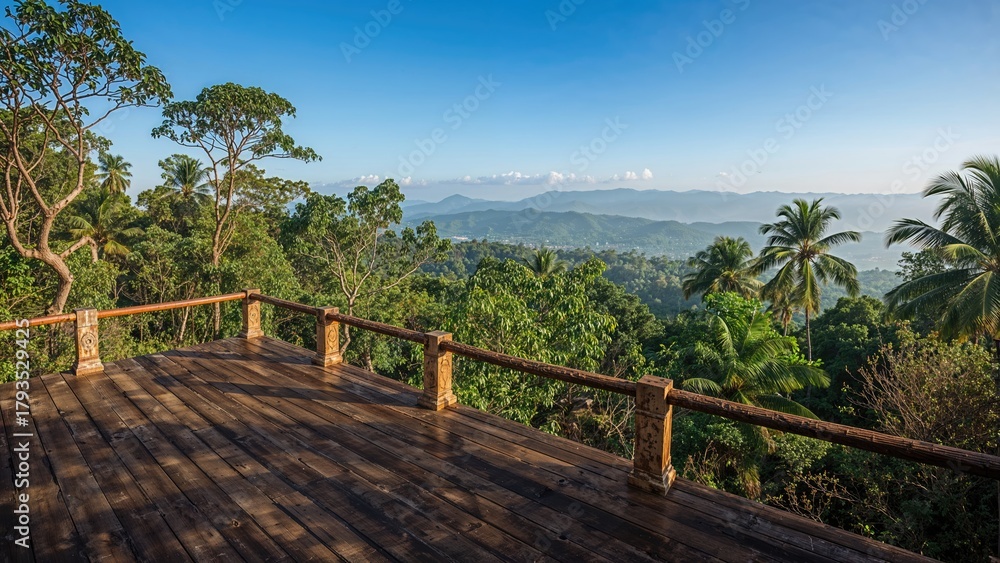 Obraz premium A wooden terrace overlooking lush green trees and distant mountains on a clear day.