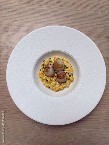 A plate of creamed corn with scallop.