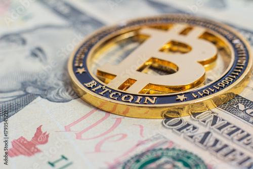 Bitcoin on the background of the 10 dollar bill