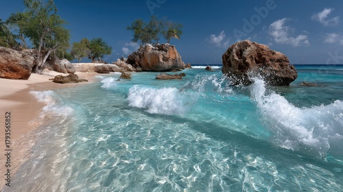 Wallpaper Mural Tropical beach scene with clear turquoise water, waves, and rock formations under a blue sky Torontodigital.ca