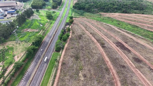 An aerial view of a highway and a harvested agricultural field