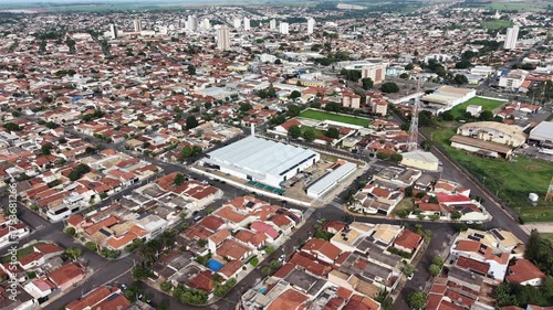 An expansive aerial view showcasing a sprawling cityscape, capturing the intricate details of a residential area with numerous houses and buildings