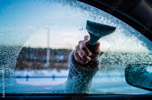 Clearing snow from windshield, Scraping ice. Winter season car window cleaning. Holiday in ski resort.	