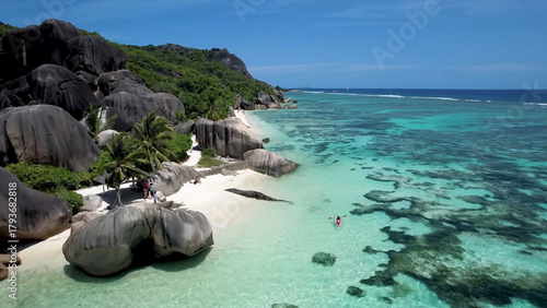 Luxury resort photo of Seychelles tropical paradise islands
in Indian Ocean with palm trees, sandy beach, stones.
Beautiful photography, coral reef, azure ocean, 
sky with clouds on horizon. 
