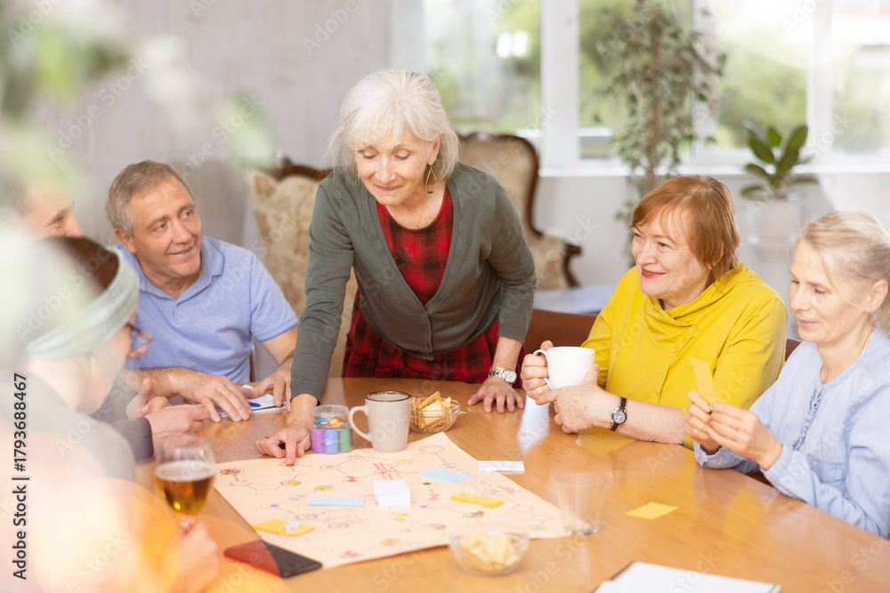 Fototapeta premium Group of senior friends at home, playing board games