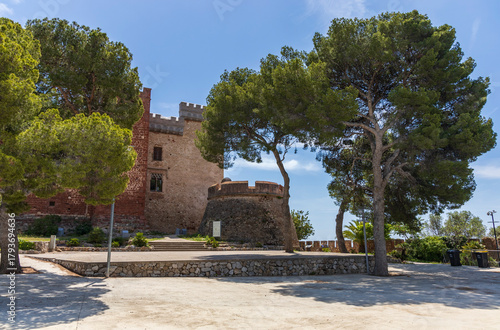 Exterior view of Castelldefels Castle, a 10th-century fortress on a sunny summer day