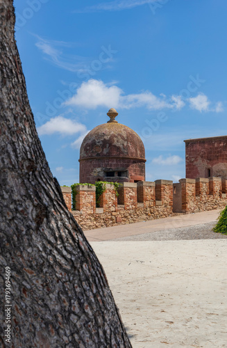 Exterior view of Castelldefels Castle, a 10th-century fortress on a sunny summer day