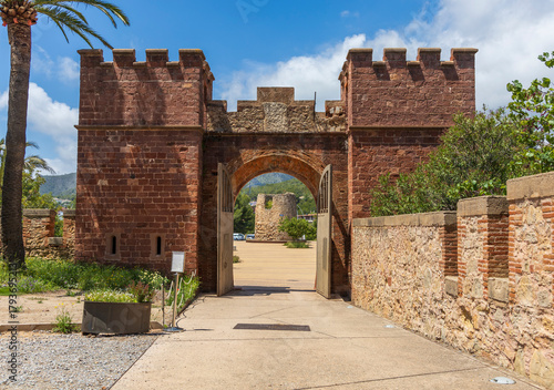 Exterior view of Castelldefels Castle, a 10th-century fortress on a sunny summer day