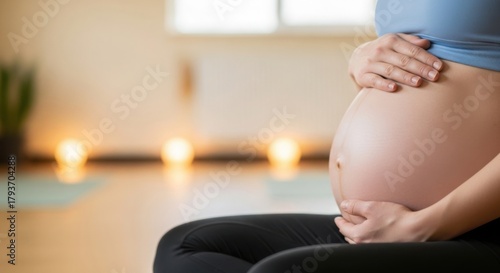 Serene pregnant woman holds baby belly in soft focus, emphasizing connection between mother and child. Pregnant woman sits peacefully, hands cradling unborn baby,