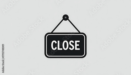 Monochrome Close Sign Hanging on a Light Gray Background.