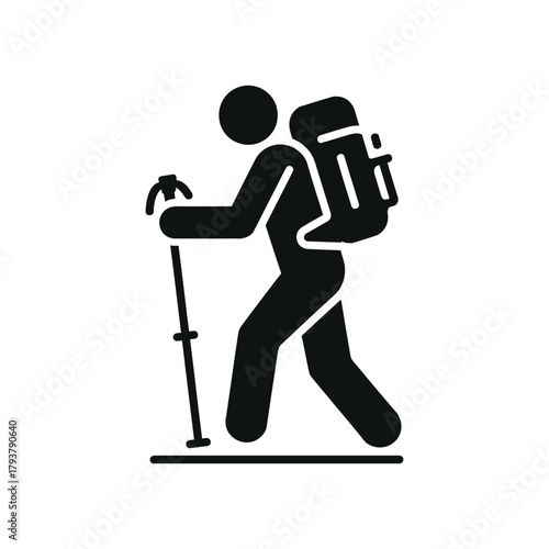 A person with a backpack and walking stick