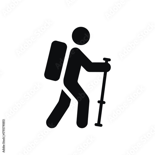 A person with a backpack and walking stick