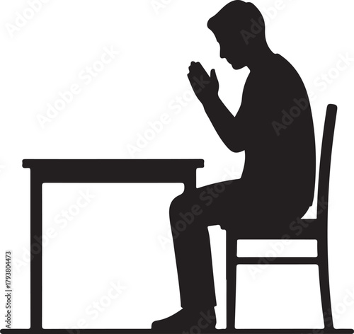 Silhouette of a person praying or meditating quietly at a table, symbolizing devotion, contemplation, or reflection in a peaceful setting