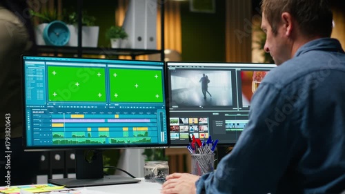 Green screen next to videographer cutting and editing video footage, web content development for cinematic montage. Color grading in post production software for new movie. Camera B.