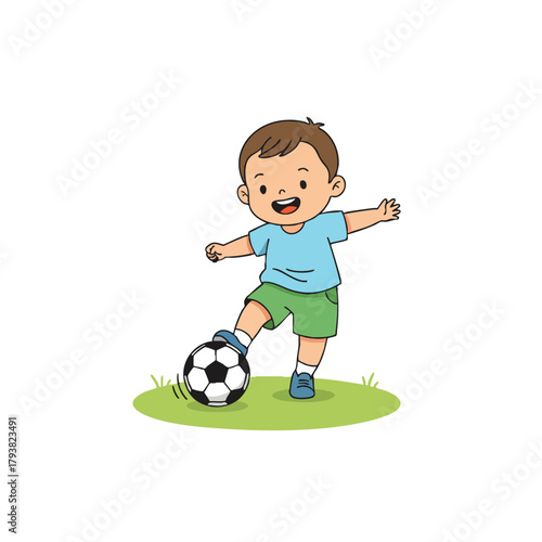 Young boy playing with a soccer ball on grass
