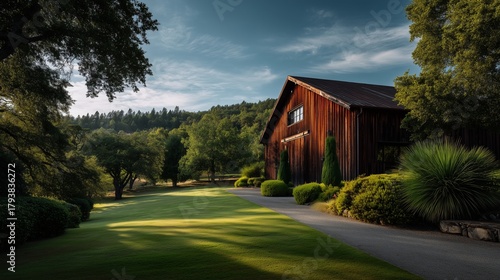 Rustic Barn Amidst the Lush Landscape: This image portrays a serene scene featuring a rustic wooden barn nestled amidst a lush, vibrant landscape under a bright sky.
