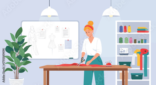 Fashion designer at work cutting fabric in her bright studio