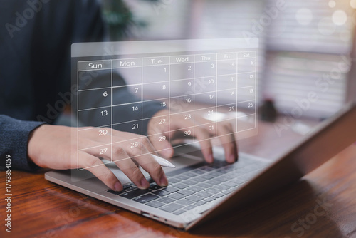 Person typing on a laptop with a digital calendar interface, representing scheduling, time management, online planning, productivity tools, appointment organization, and efficient workflow in modern.