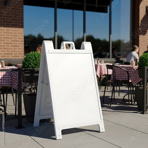 Blank White A-Frame Sign on Restaurant Patio for Custom Messaging.