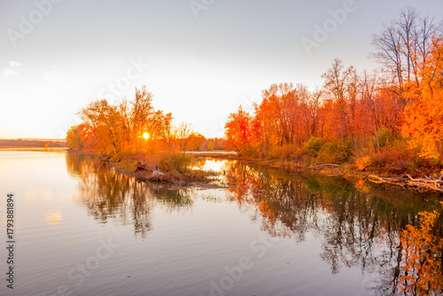 Colorful fall leaves with beatiful sunset on the lake