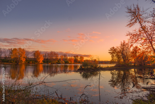 Colorful fall leaves with beatiful sunset on the lake
