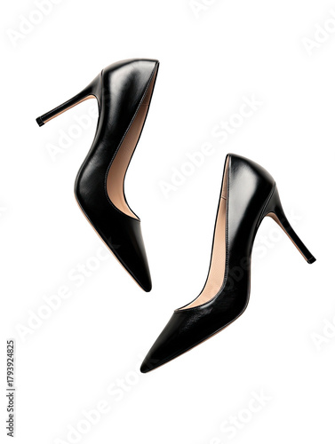 Two glossy black stiletto heels floating on a dark background