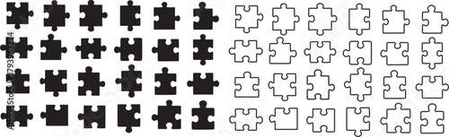 Black silhouette puzzle pieces arranged in various sizes and shapes.	