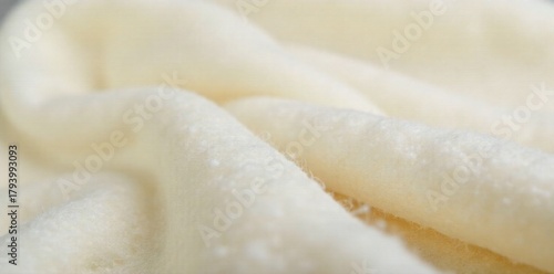 Cozy woolly textures for soft, inviting backgrounds A close up, high resolution studio shot of a pure white, tightly woven wool fabric with a very subtle, soft nap. The lighting is even and diffused,