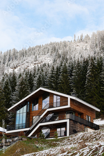 Modern mountain chalet home with stunning winter forest view