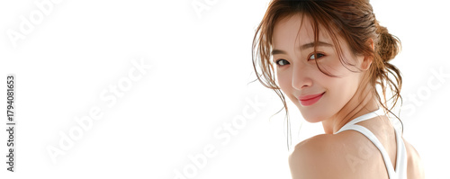 An Asain woman with long black hair wearing a white tank top poses confidently for the camera, showcasing fresh beauty against a clean white background.
