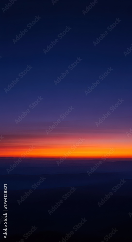 Obraz premium Serene evening twilight sky with deep indigo and vibrant orange hues, casting atmospheric shadows across a vast, peaceful landscape scene, gradient, dramatic, environment