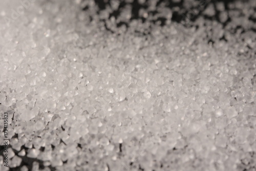 Close-up of the surface of white salt grains, macro salt