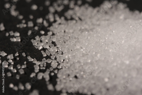 Close-up of the surface of white salt grains, macro salt