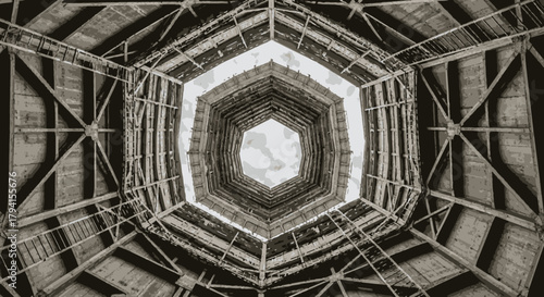 A mesmerizing low-angle view showcases the intricate geometric patterns and symmetrical design of a vintage architectural ceiling, leading the eye upwards towards a bright sky.