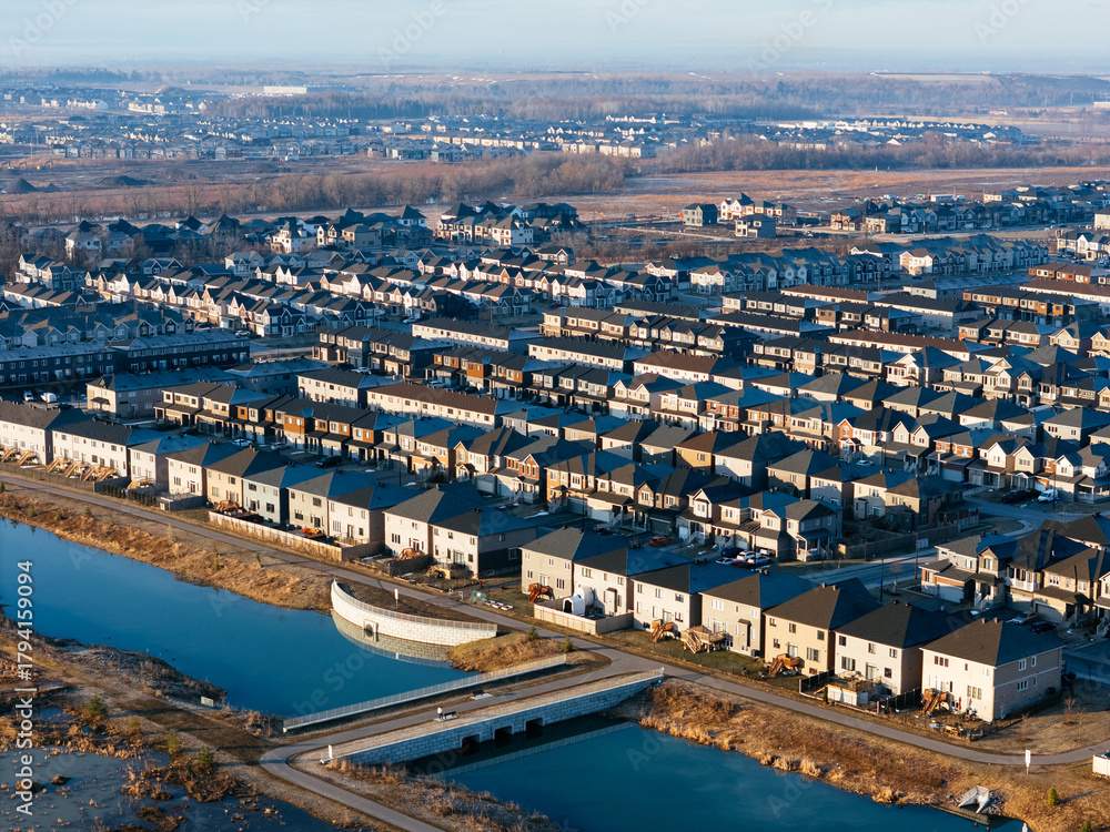 Obraz premium Aerial view of Barrhaven suburban housing development in Ottawa during early winter morning light. g.
