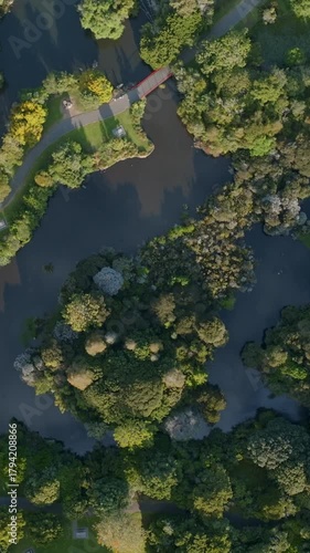 Aerial view of Western Springs park in Auckland, New Zealand. The park features a lake, walking paths, playground, and lush greenery. A popular destination for recreation.