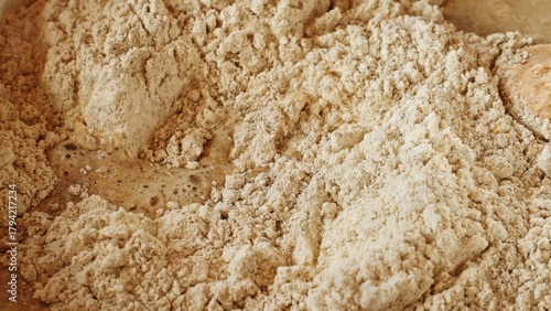 Macro close-up of flour kneading dough. Traditional healthy sourdough rye bread recipe. Gluten-free diet food, healthy baking. Bakery, handmade bread, pizza, culinary arts. Diy yeast dough baking ads