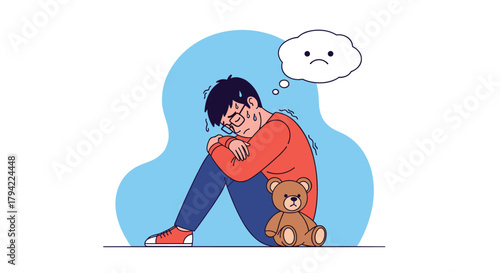 A stressed young man sits huddled on the floor with a teddy bear, a sad thought bubble above him, symbolizing anxiety and depression.