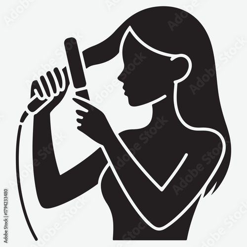 Silhouette of a woman using a hair straightener to style her long hair
