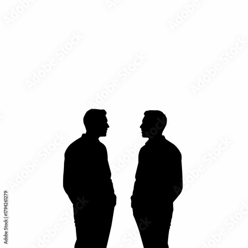 Two men standing facing each other in silhouette.