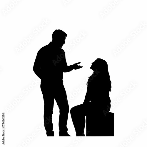 Silhouette of a man standing and talking to a seated woman.