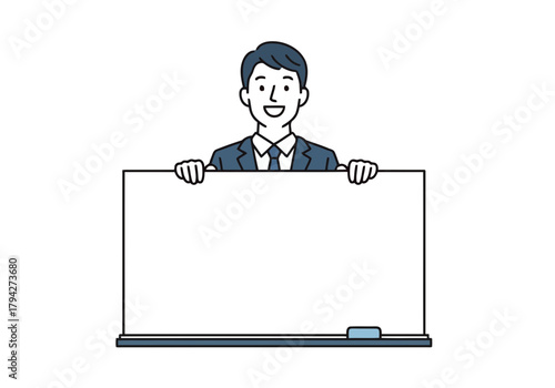 Smiling businessman in a suit holding a blank whiteboard, ready to present information or ideas to an audience