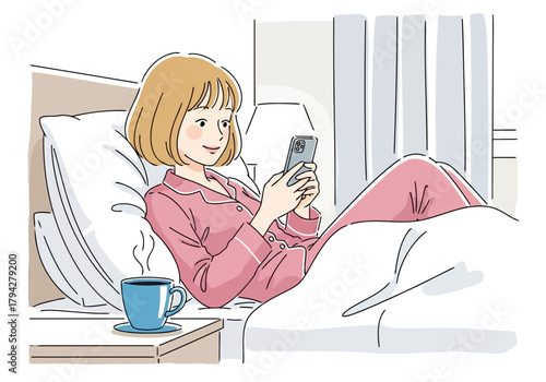 Woman in pink pajamas lying in bed, looking at her phone with a cup of coffee on the nightstand