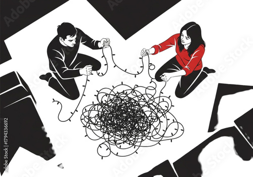 A man and a woman kneeling on the floor untangling a large messy pile of string lights.