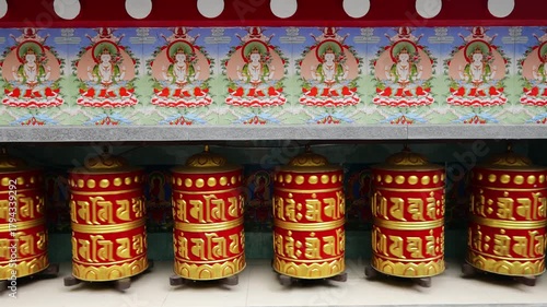 Rotating brass prayer wheels in Nepal monastery. Buddhist symbols, mantra engraving, spinning motion, cultural heritage, traditional ritual, spiritual architecture, Himalayas stock video