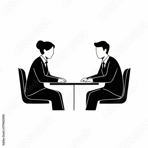 Business meeting between two people at a table discussing work.