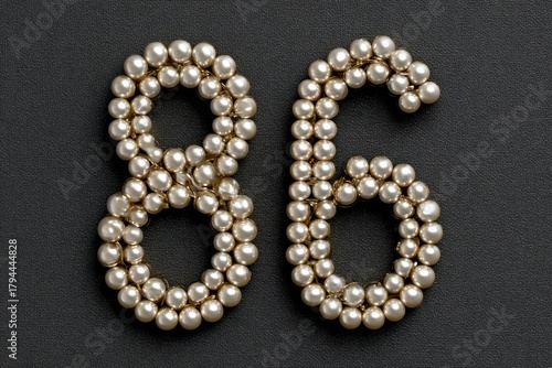 Elegant Pearls Forming Numbers Eight and Six on Dark Background
