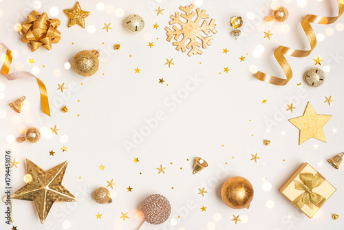 Christmas decoration gold color objects on light background with holiday ornament and copy space in center