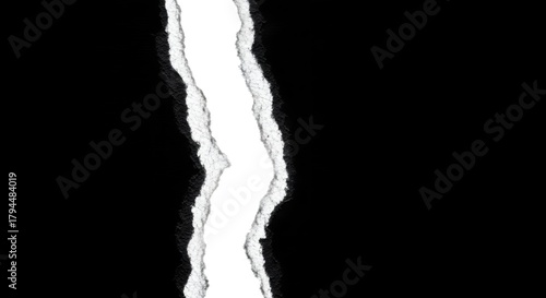 A black background with a jagged white tear down the center.