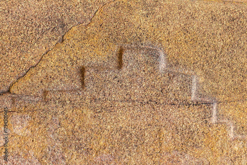 Canvastavla Ollantaytambo, Sacred Valley, Peru: detailed close-up of Inca stone carving showing the stepped cross or Chakana symbol, representing the Andean worldview and Inca sacred geometry